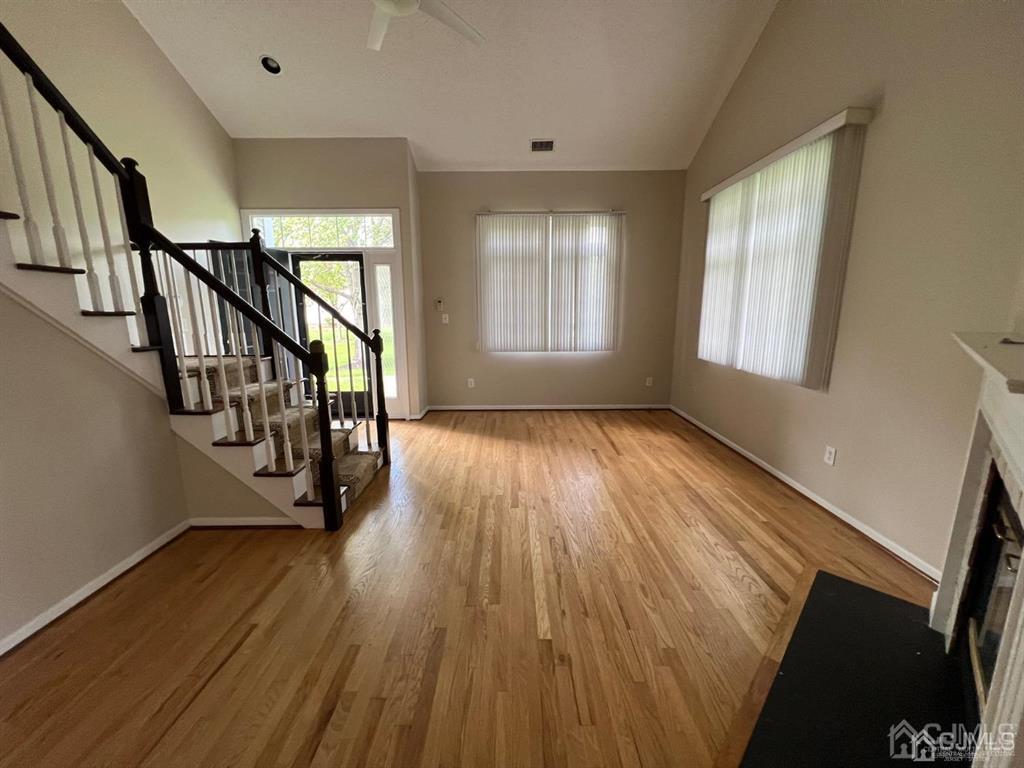 59 Winthrop Road, Unit 59A Monroe Township, NJ 08831 - Photo 4 of 13 a view of an empty room with wooden floor and windows