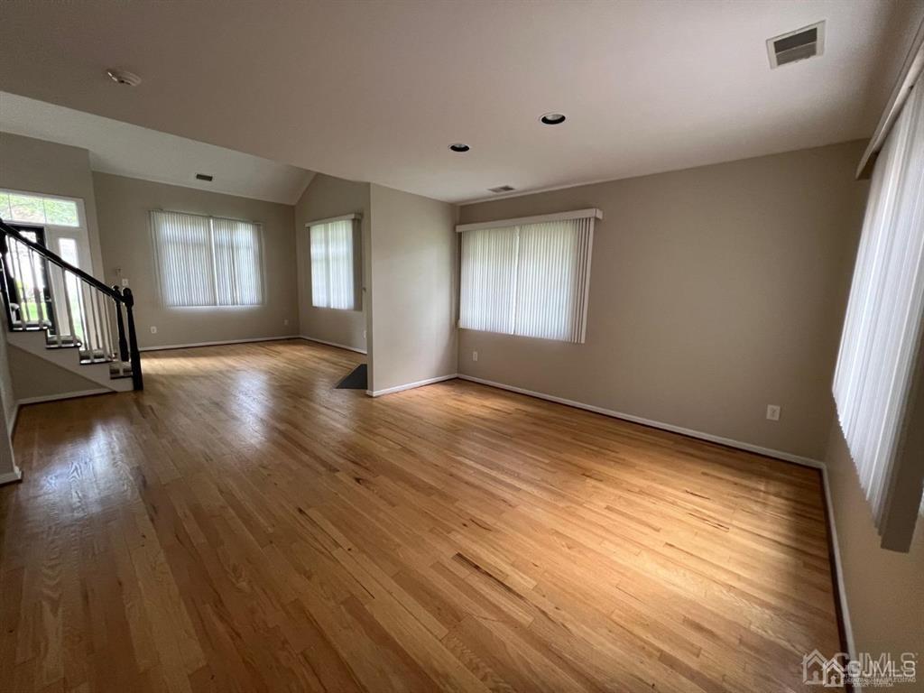 59 Winthrop Road, Unit 59A Monroe Township, NJ 08831 - Photo 5 of 13 an empty room with wooden floor and windows