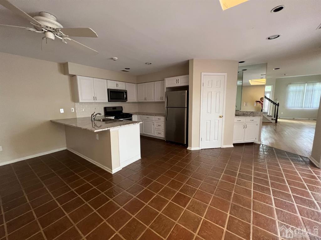 59 Winthrop Road, Unit 59A Monroe Township, NJ 08831 - Photo 6 of 13 a kitchen with stainless steel appliances a refrigerator sink and microwave