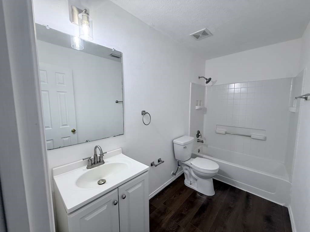 1011 Backland Court Spring, TX 77373 - Photo 21 of 35 a bathroom with a sink toilet a mirror and vanity