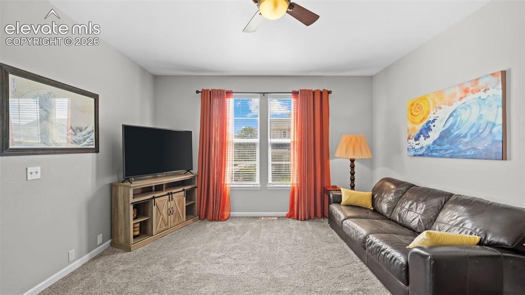 4023 Diamond Ridge View Colorado Springs, CO 80918 - Photo 6 of 31 a living room with furniture and a flat screen tv