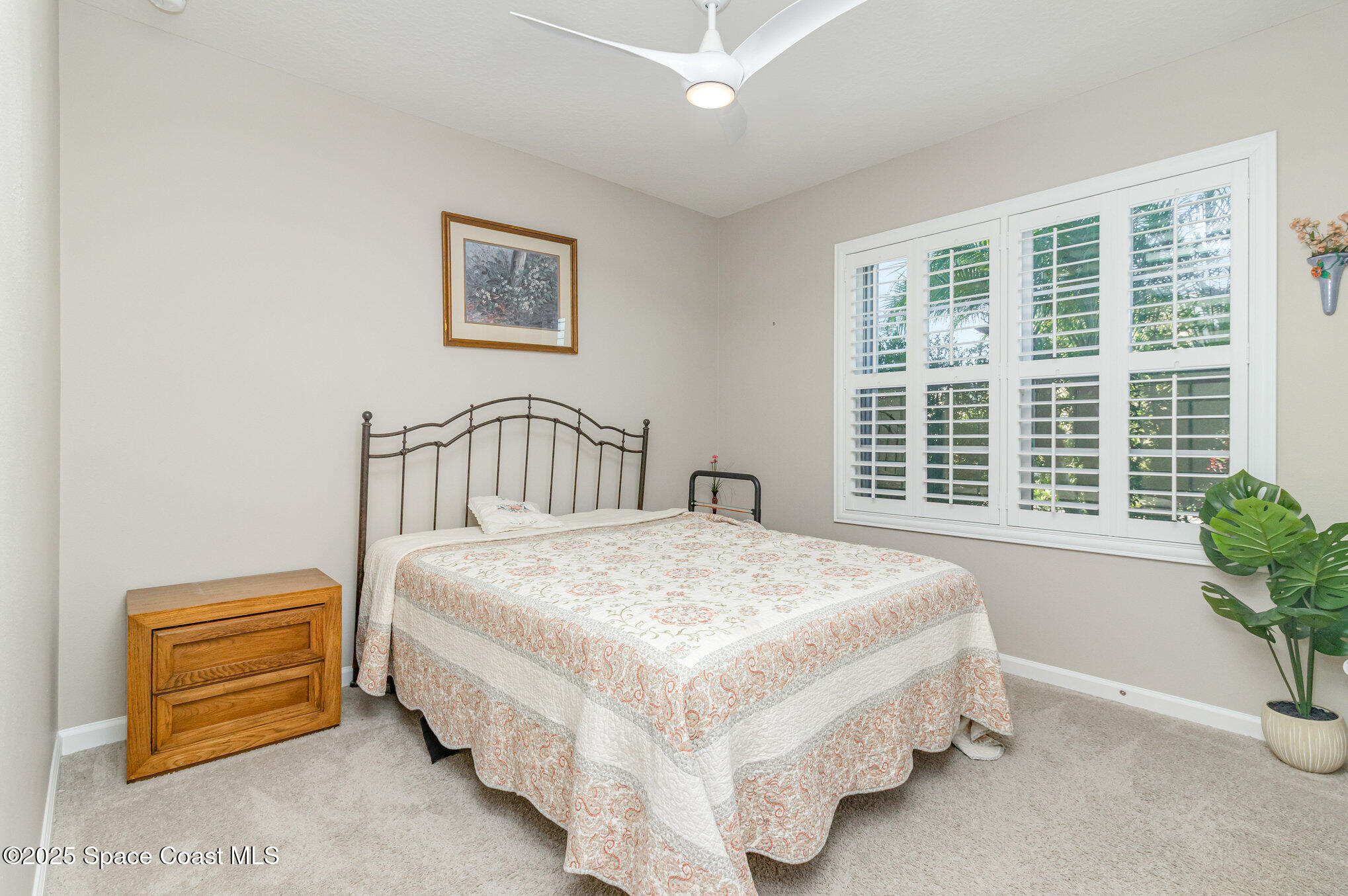 1110 Swiss Pointe Lane Rockledge, FL 32955 - Photo 16 of 26 a bedroom with a bed next to a window