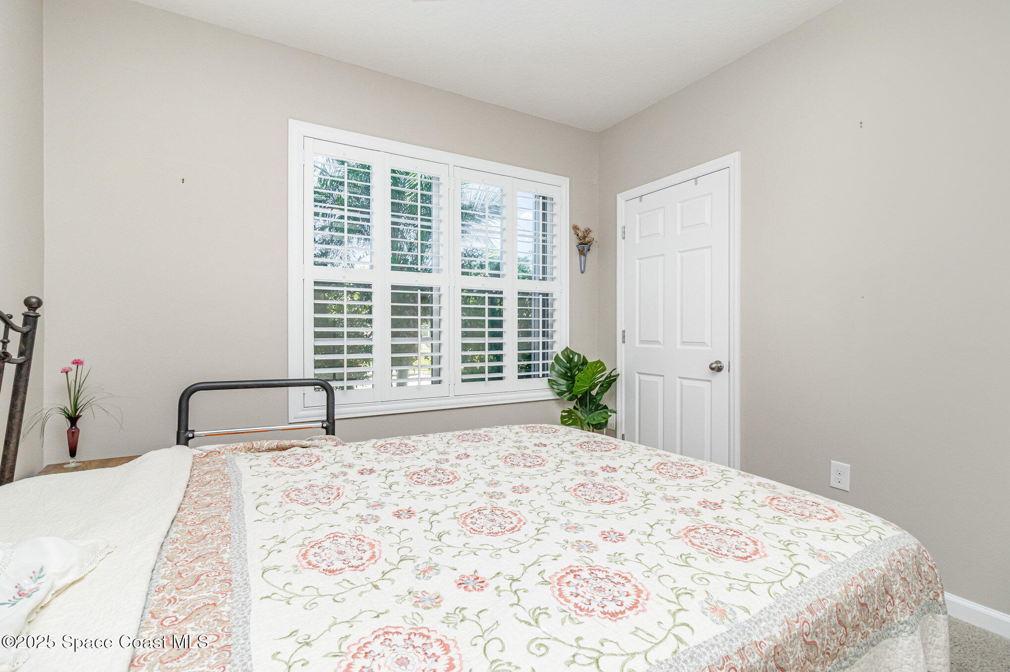 1110 Swiss Pointe Lane Rockledge, FL 32955 - Photo 17 of 26 a bedroom with a bed and a large window