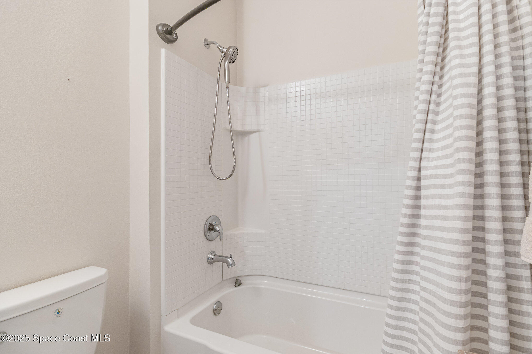 1110 Swiss Pointe Lane Rockledge, FL 32955 - Photo 19 of 26 a bathroom with a bath tub and a shower curtain