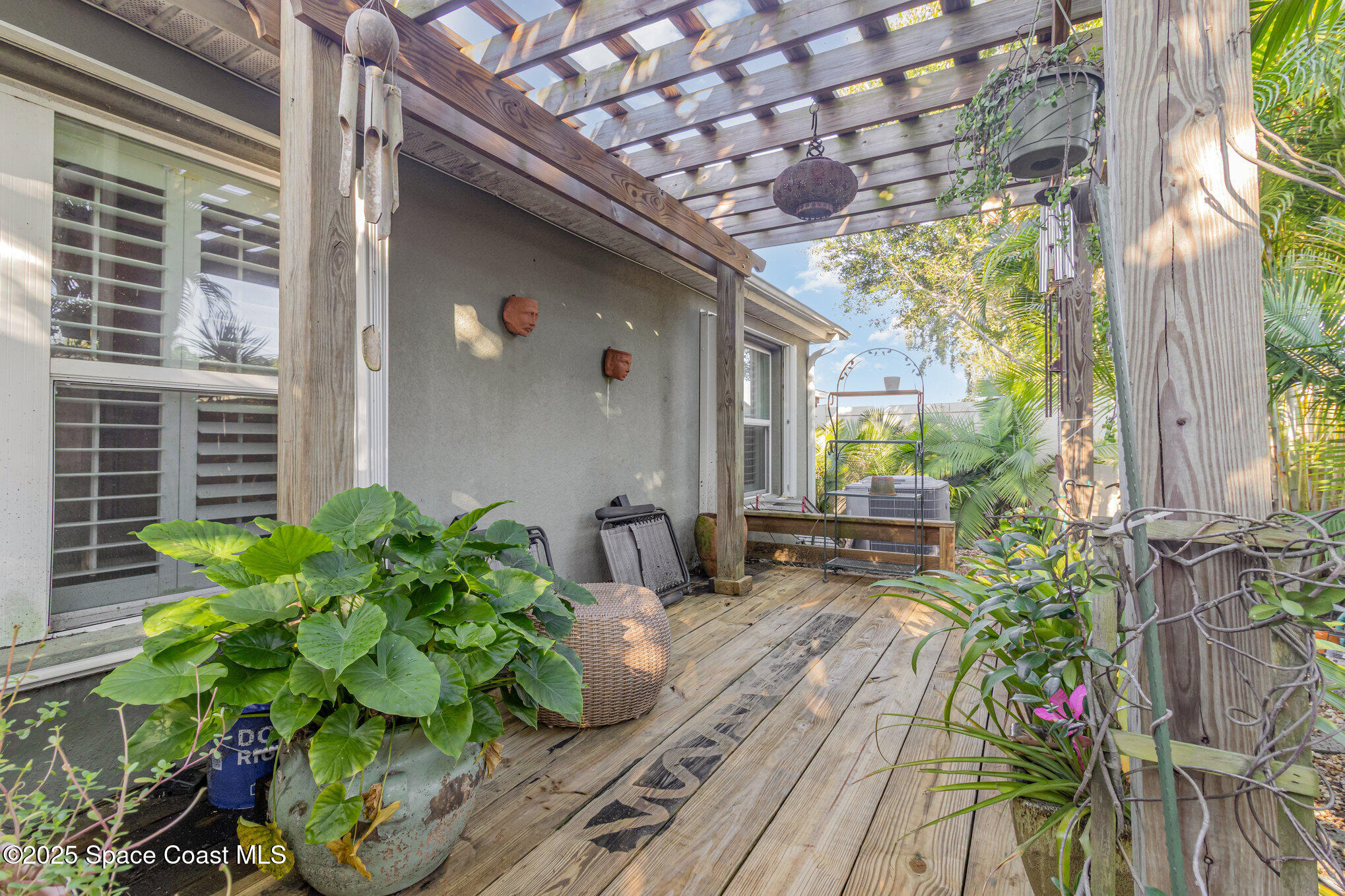 1110 Swiss Pointe Lane Rockledge, FL 32955 - Photo 24 of 26 a house with potted plants in front of door