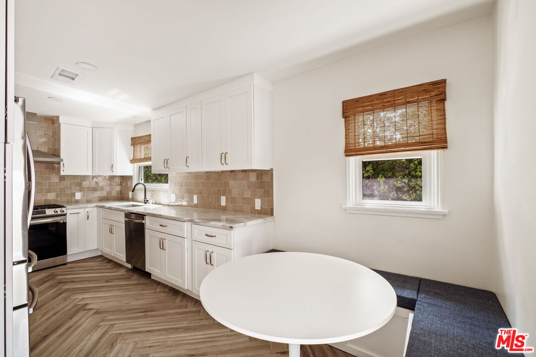 2375 Catherine Road Altadena, CA 91001 - Photo 10 of 26 a kitchen with stainless steel appliances granite countertop a stove a sink dishwasher and a refrigerator with wooden floor
