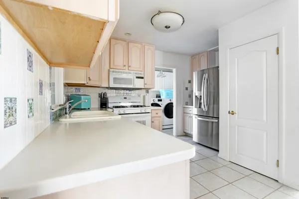 a kitchen with stainless steel appliances a stove a sink and cabinets