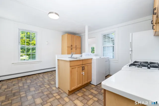a kitchen that has a sink a stove and window