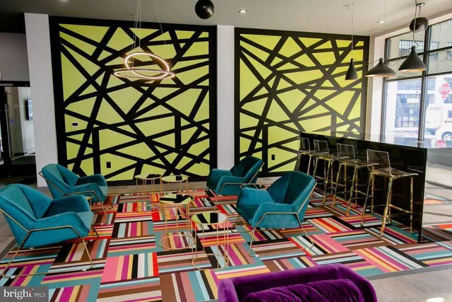 a kitchen with stainless steel appliances granite countertop a kitchen island a stove a table and chairs