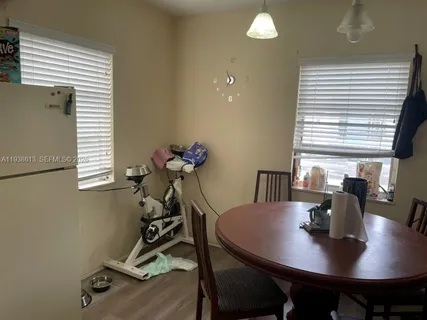 a view of a dining room with furniture and window