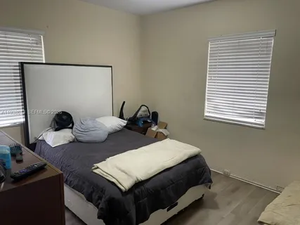 a bedroom with bed and a window