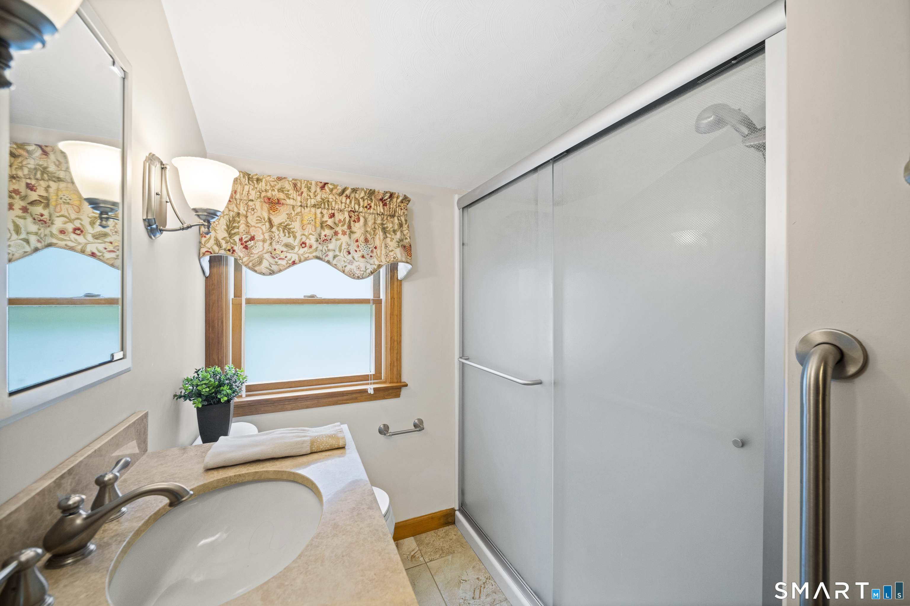 6 Cartier Road Enfield, CT 06082 - Photo 31 of 40 a bathroom with a granite countertop sink a mirror and a shower