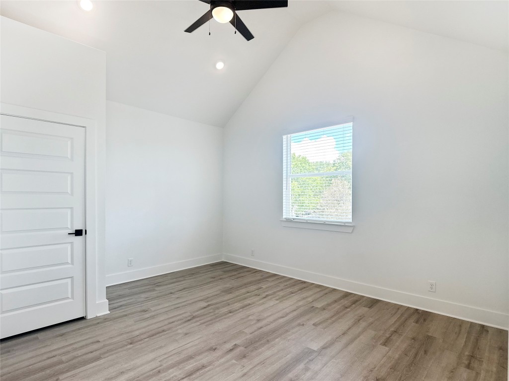 6107 Begonia Circle, Unit 3 Austin, TX 78741 - Photo 13 of 21 an empty room with a hardwood and ceiling fan