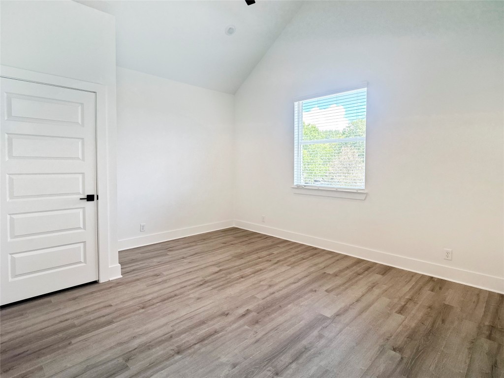 6107 Begonia Circle, Unit 3 Austin, TX 78741 - Photo 14 of 21 an empty room with wooden floor closet and windows