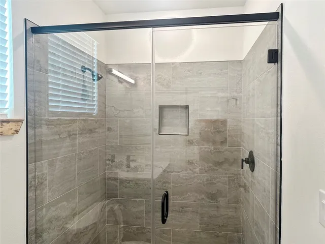 a bathroom with a shower and a shower head