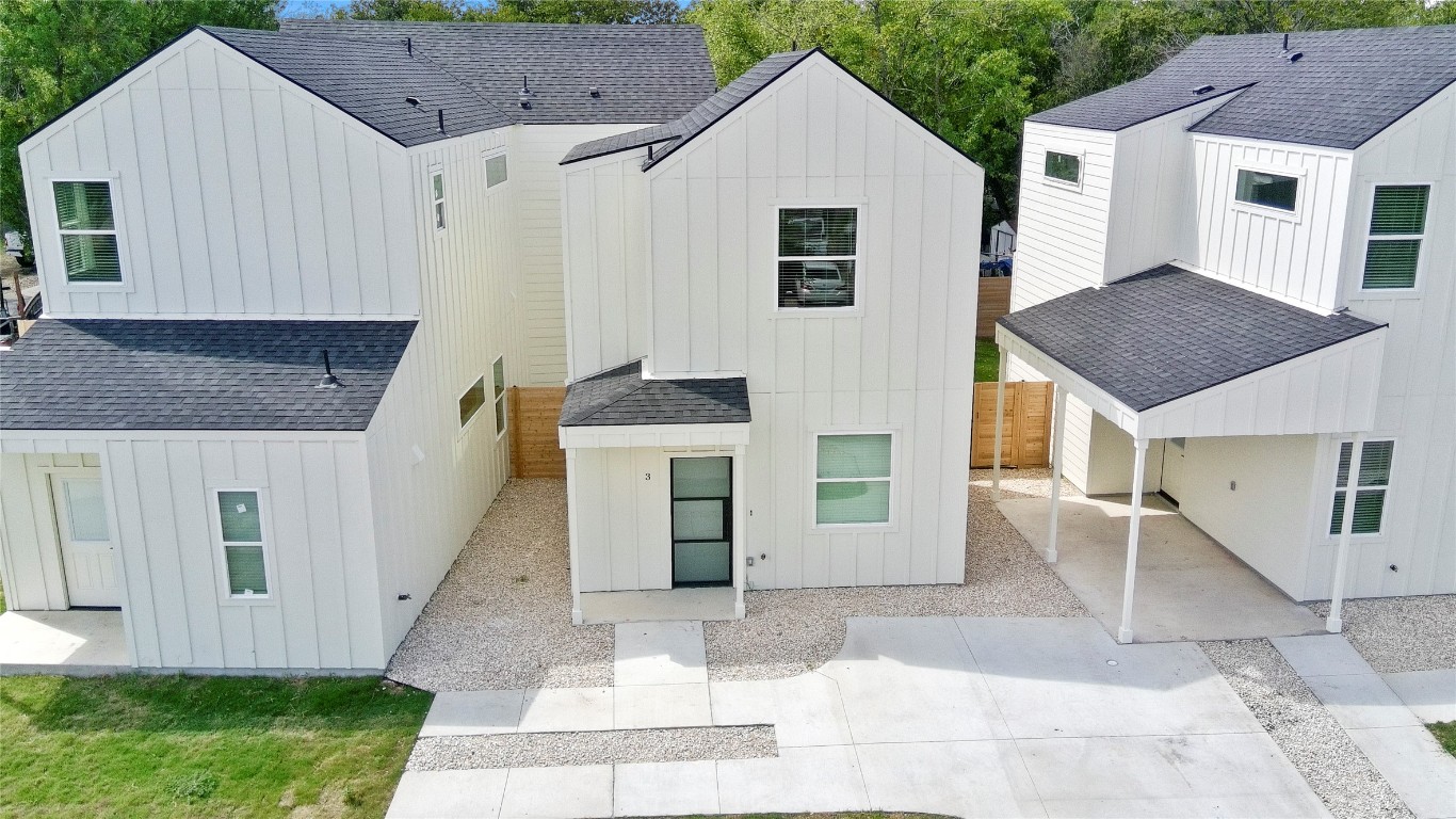 6107 Begonia Circle, Unit 3 Austin, TX 78741 - Photo 21 of 21 a view of a white house with a yard plants and large tree
