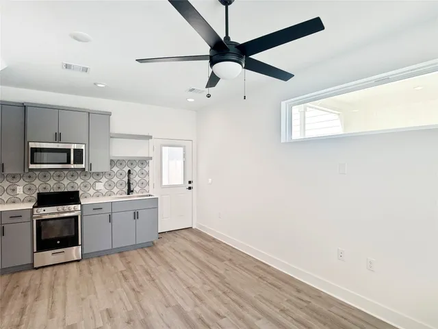 a kitchen with stainless steel appliances granite countertop a stove and a refrigerator