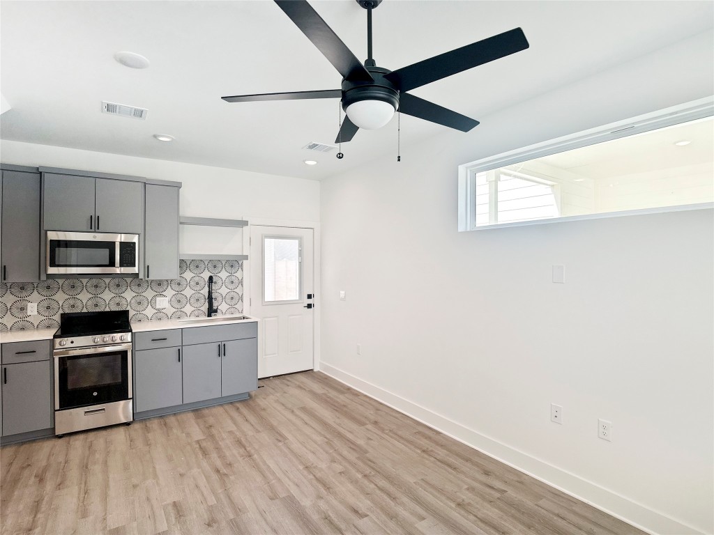 6107 Begonia Circle, Unit 3 Austin, TX 78741 - Photo 4 of 21 a kitchen with stainless steel appliances granite countertop a stove and a refrigerator