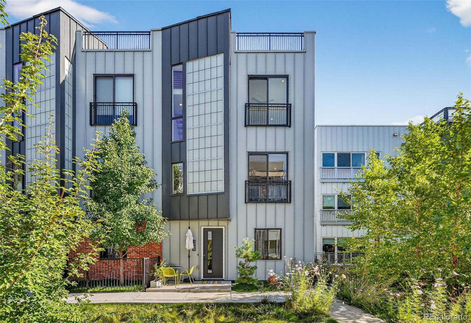 1150 26th Street Denver, CO 80205 - Photo 1 of 50 a front view of a house with plants and entryway
