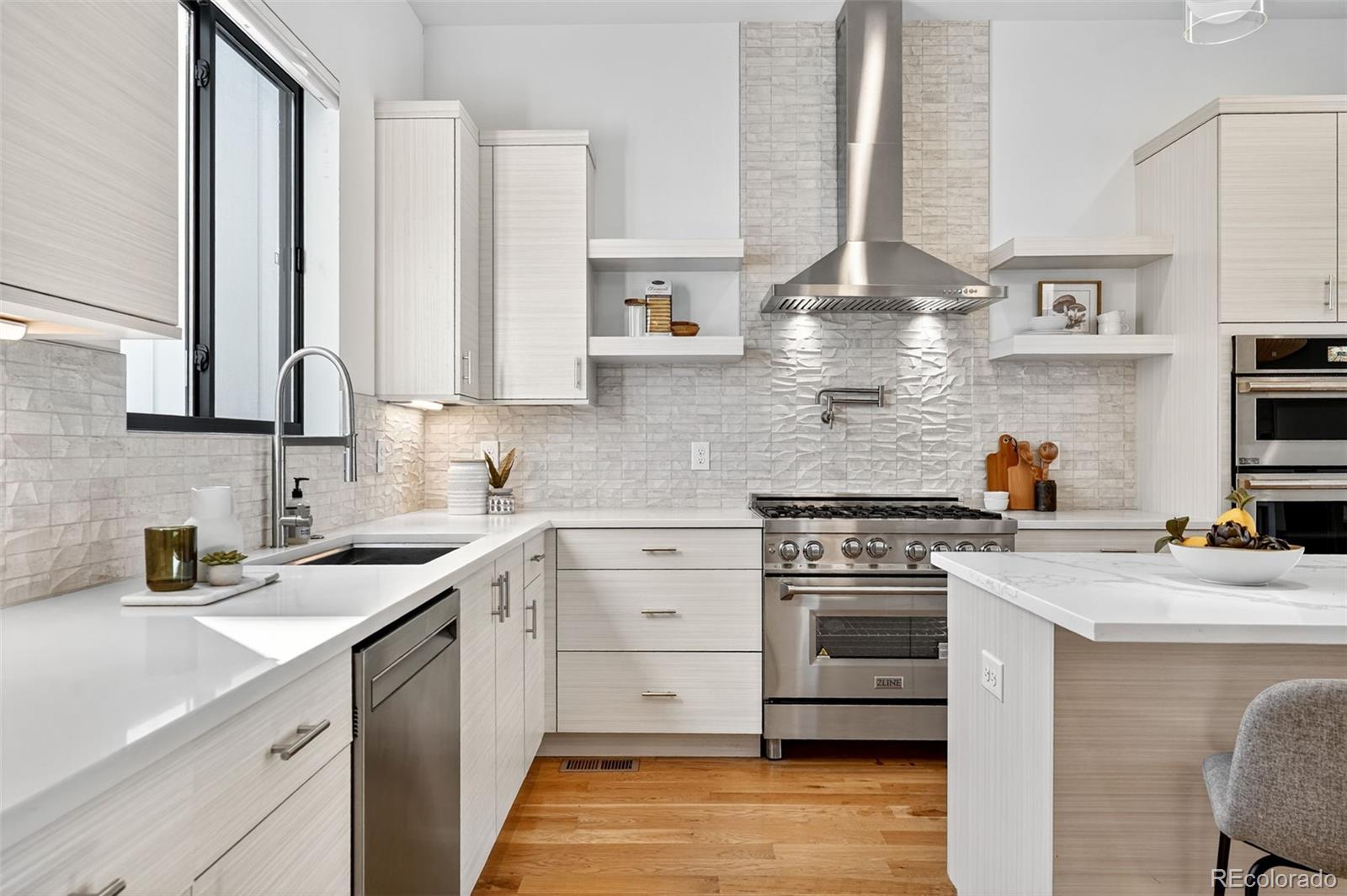 1150 26th Street Denver, CO 80205 - Photo 2 of 50 a kitchen with stainless steel appliances a stove sink and cabinets