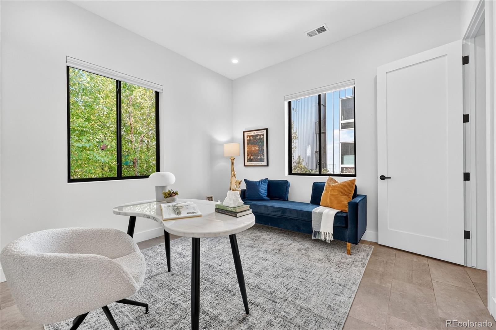 1150 26th Street Denver, CO 80205 - Photo 31 of 50 a living room with furniture and a window