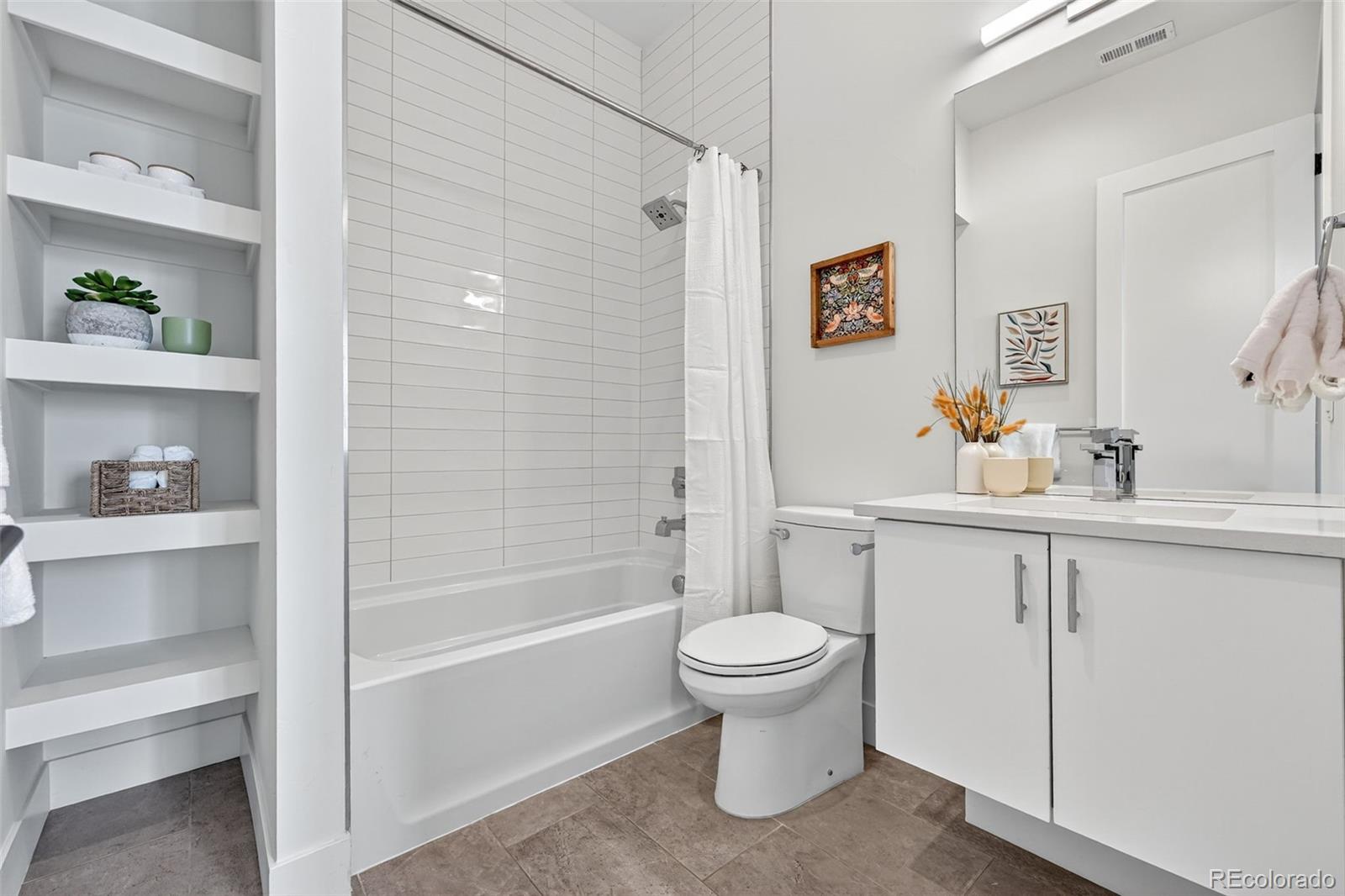 1150 26th Street Denver, CO 80205 - Photo 33 of 50 a bathroom with a sink toilet and shower