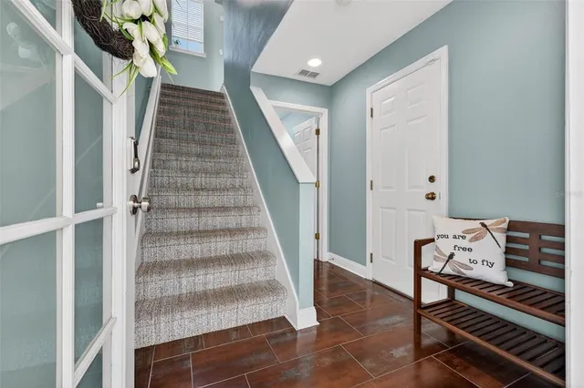 a view of entryway and hall with wooden floor