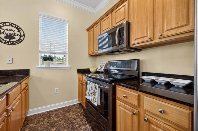 a kitchen with stainless steel appliances granite countertop a stove and a microwave