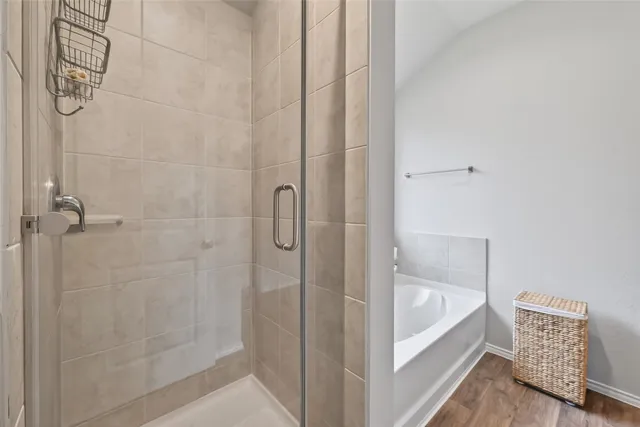 a white bath tub sitting next to a shower