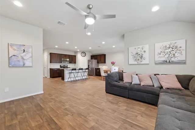 a living room with furniture and kitchen view