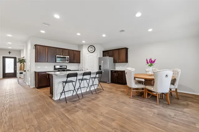 a living room with furniture and kitchen view