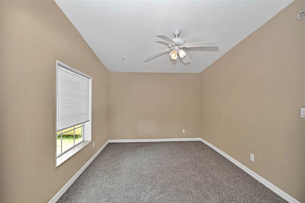18546 Northeast 5th Terrace Road Citra, FL 32113 - Photo 26 of 30 a view of room with window and ceiling fan