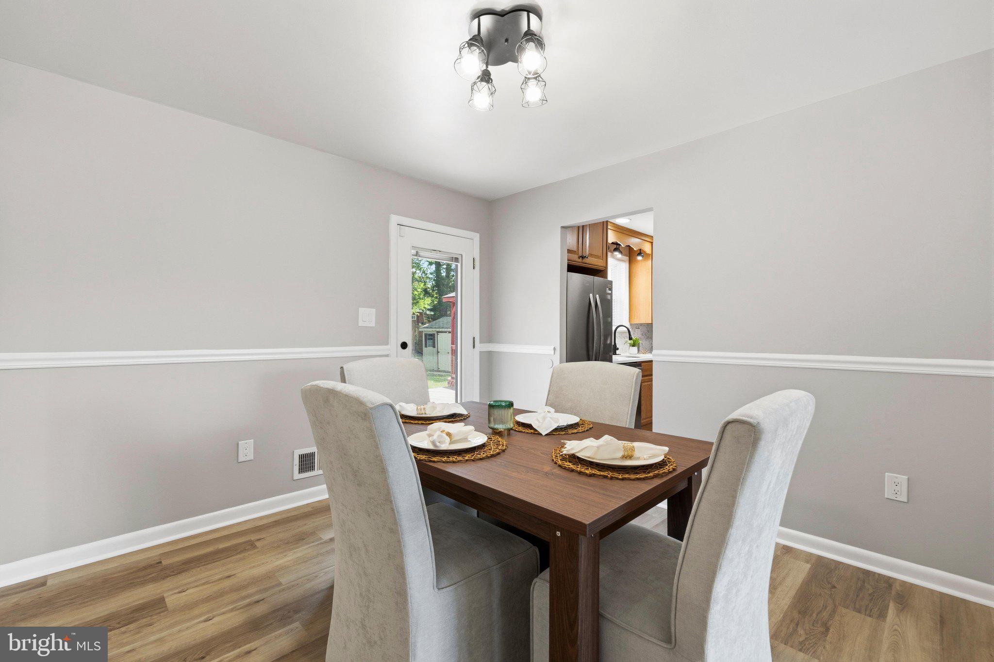 5804 Spell Road Clinton, MD 20735 - Photo 25 of 58 Dining room with modern lighting and chair rail