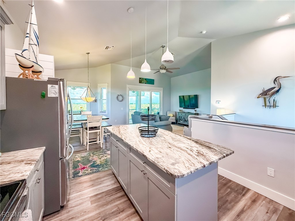 631 Rum Road Upper Captiva, FL 33924 - Photo 17 of 50 a open kitchen with granite countertop a sink stove and cabinets
