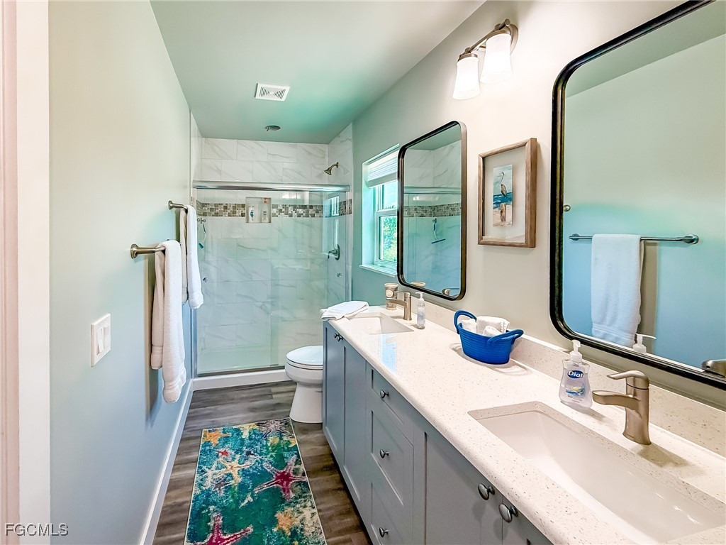 631 Rum Road Upper Captiva, FL 33924 - Photo 23 of 50 a bathroom with a double vanity sink mirror and shower