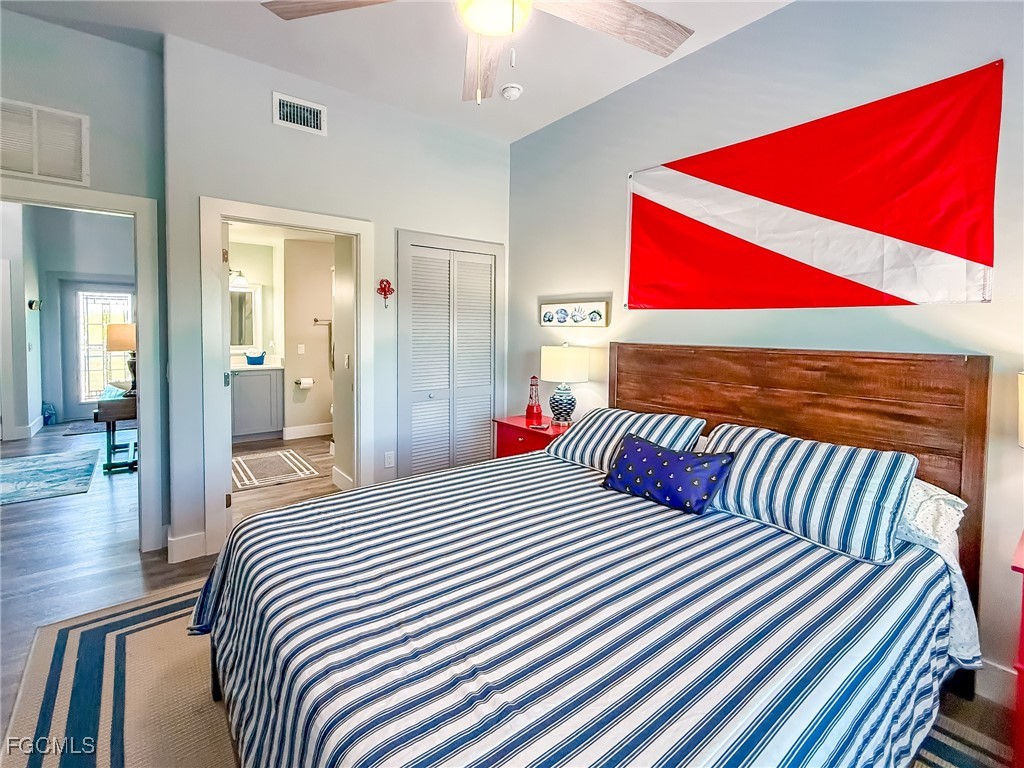 631 Rum Road Upper Captiva, FL 33924 - Photo 26 of 50 a bedroom with a bed and wooden floor