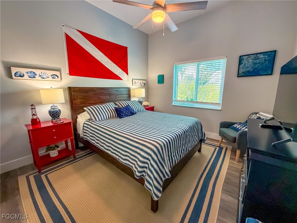 631 Rum Road Upper Captiva, FL 33924 - Photo 27 of 50 a bedroom with a bed and wooden floor