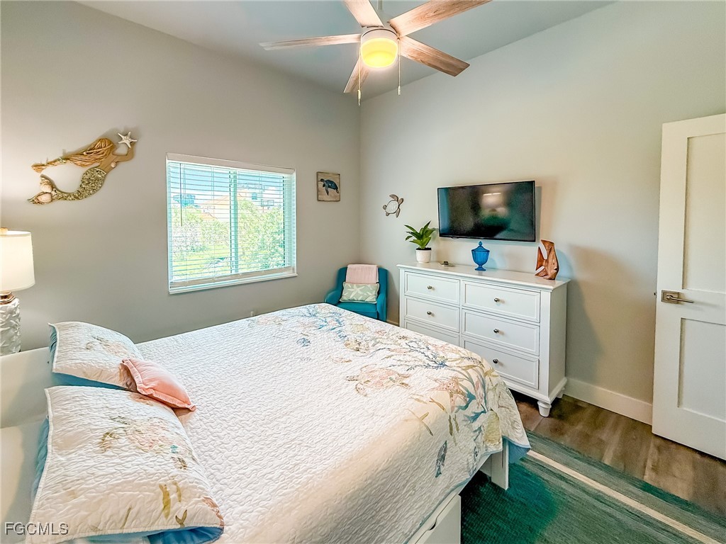 631 Rum Road Upper Captiva, FL 33924 - Photo 30 of 50 a bedroom with a bed and a flat screen tv