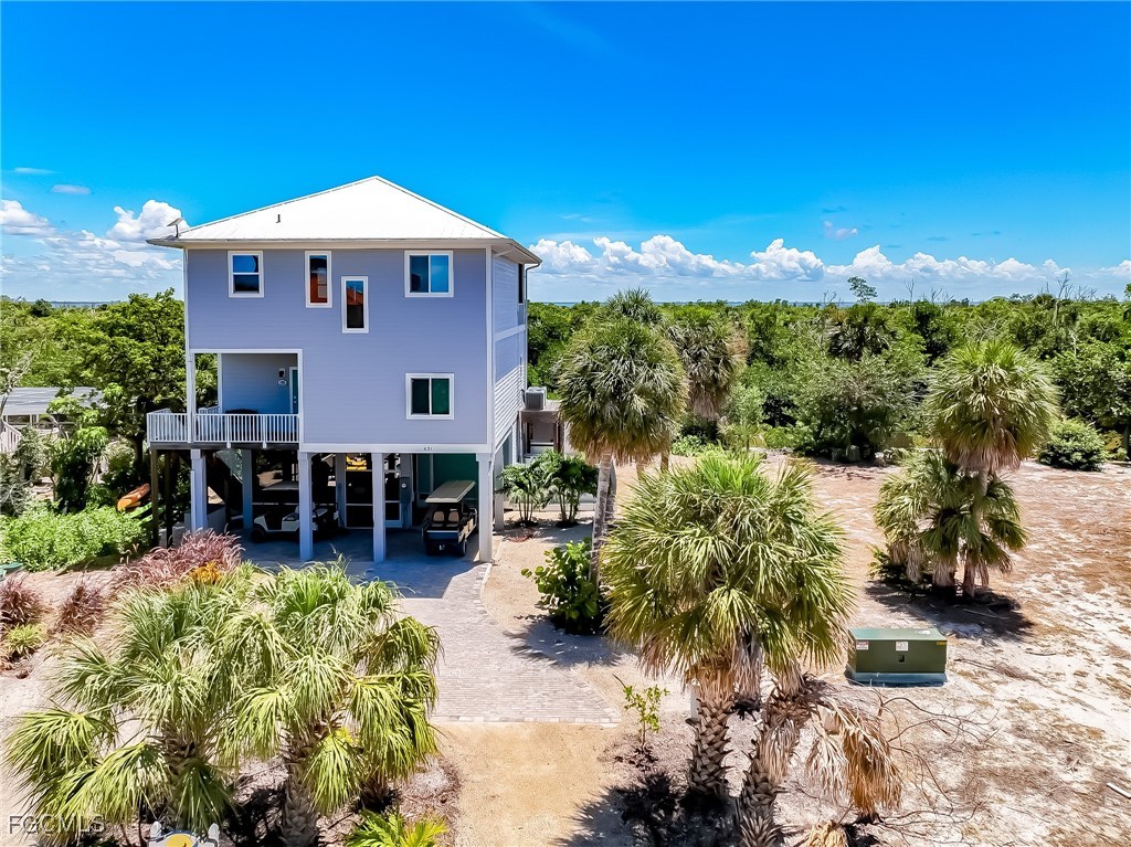 631 Rum Road Upper Captiva, FL 33924 - Photo 3 of 50 a front view of a house with a yard
