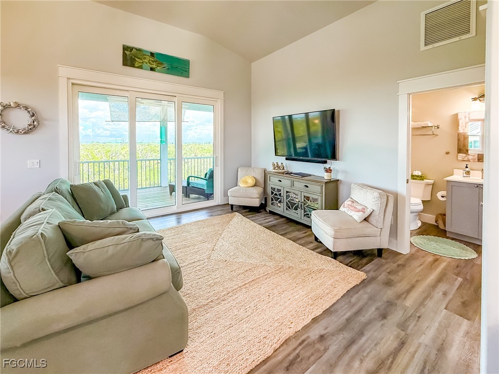 631 Rum Road Upper Captiva, FL 33924 - Photo 35 of 50 a living room with furniture and a flat screen tv