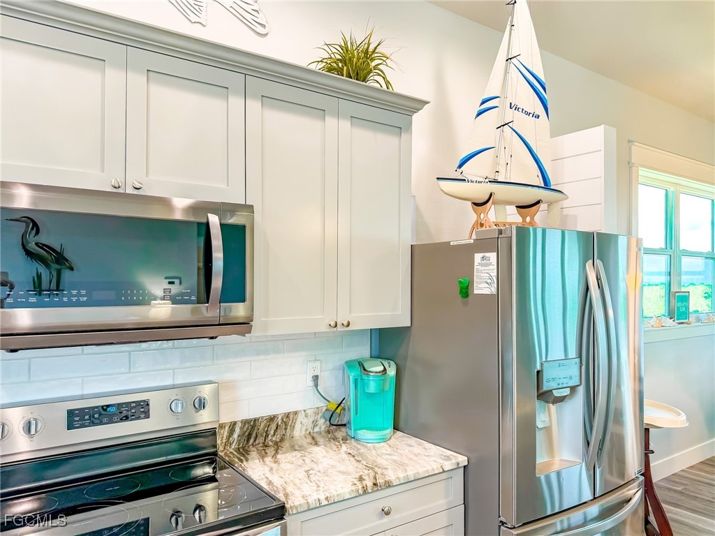 631 Rum Road Upper Captiva, FL 33924 - Photo 38 of 50 a kitchen with stainless steel appliances a stove and a refrigerator