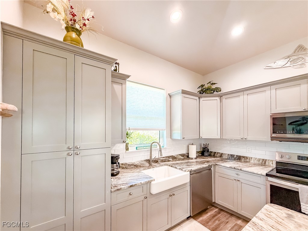631 Rum Road Upper Captiva, FL 33924 - Photo 40 of 50 a kitchen with a sink appliances cabinets and furniture