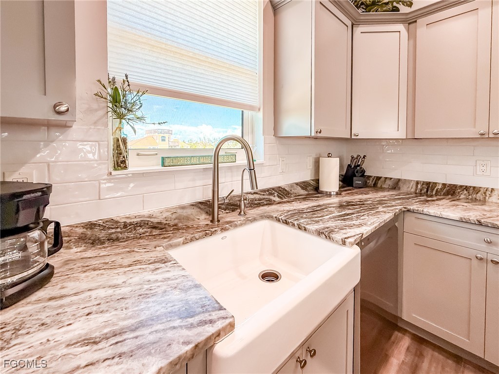 631 Rum Road Upper Captiva, FL 33924 - Photo 41 of 50 a kitchen with granite countertop a sink a stove and cabinets