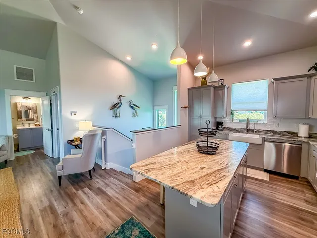 a kitchen with a stove and a wooden floor