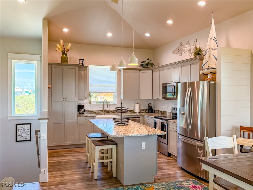 631 Rum Road Upper Captiva, FL 33924 - Photo 44 of 50 a kitchen with kitchen island a counter top space a sink stainless steel appliances and cabinets