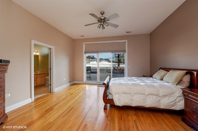 3747 North Clark Street, Unit 2N Chicago, IL 60613 - Photo 6 of 10 a bedroom with a bed and a table