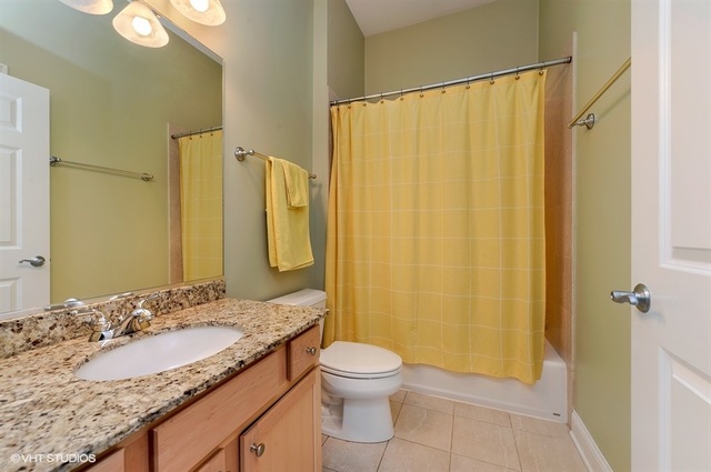 3747 North Clark Street, Unit 2N Chicago, IL 60613 - Photo 8 of 10 a bathroom with a granite countertop sink toilet and shower