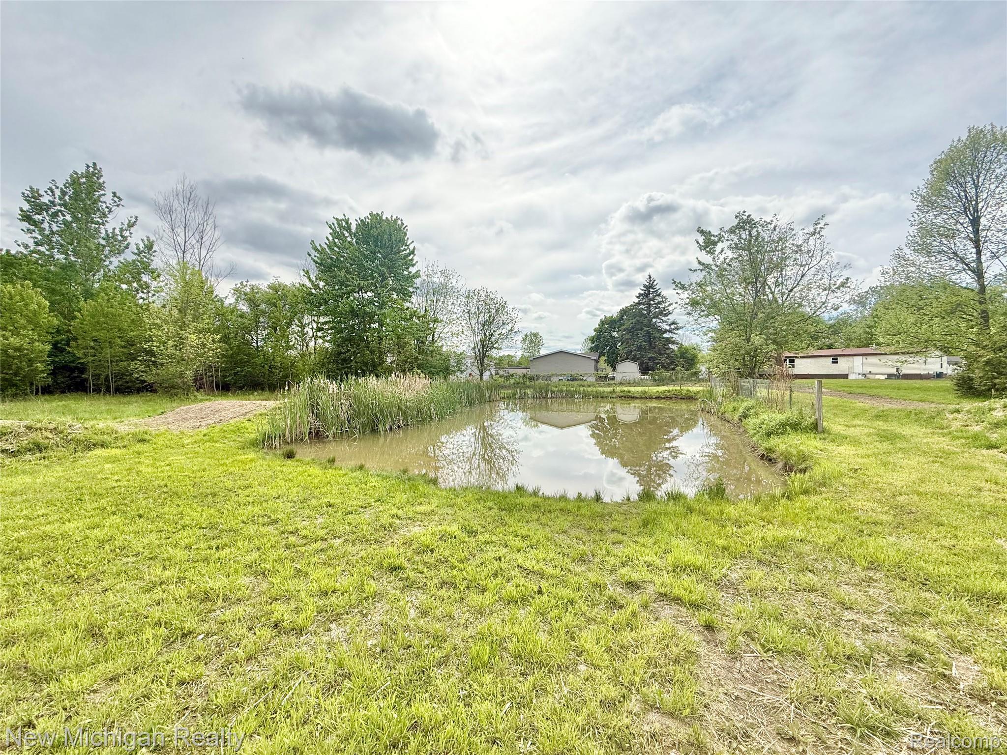 5288 Torrey Road Flint, MI 48507 - Photo 40 of 41 Expansive green space featuring a natural pond