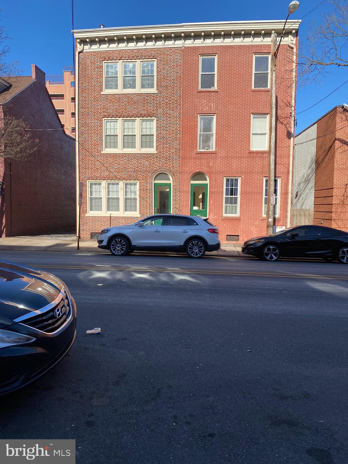 a couple of cars parked in front of a building