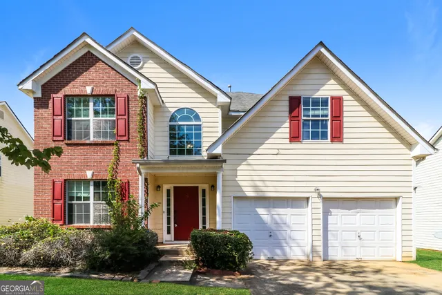 a front view of a house with a yard